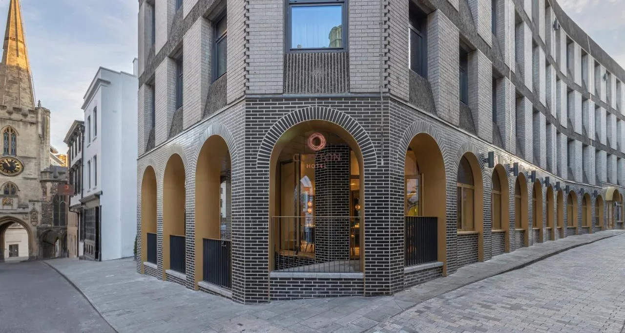 a brick building on a street with a church at Clayton Hotel Bristol City in Bristol