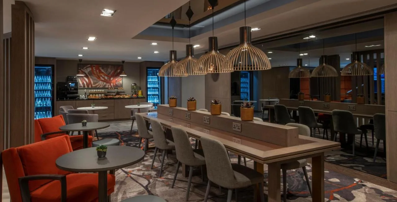 a restaurant with a bar with tables and chairs at Clayton Hotel Bristol City in Bristol